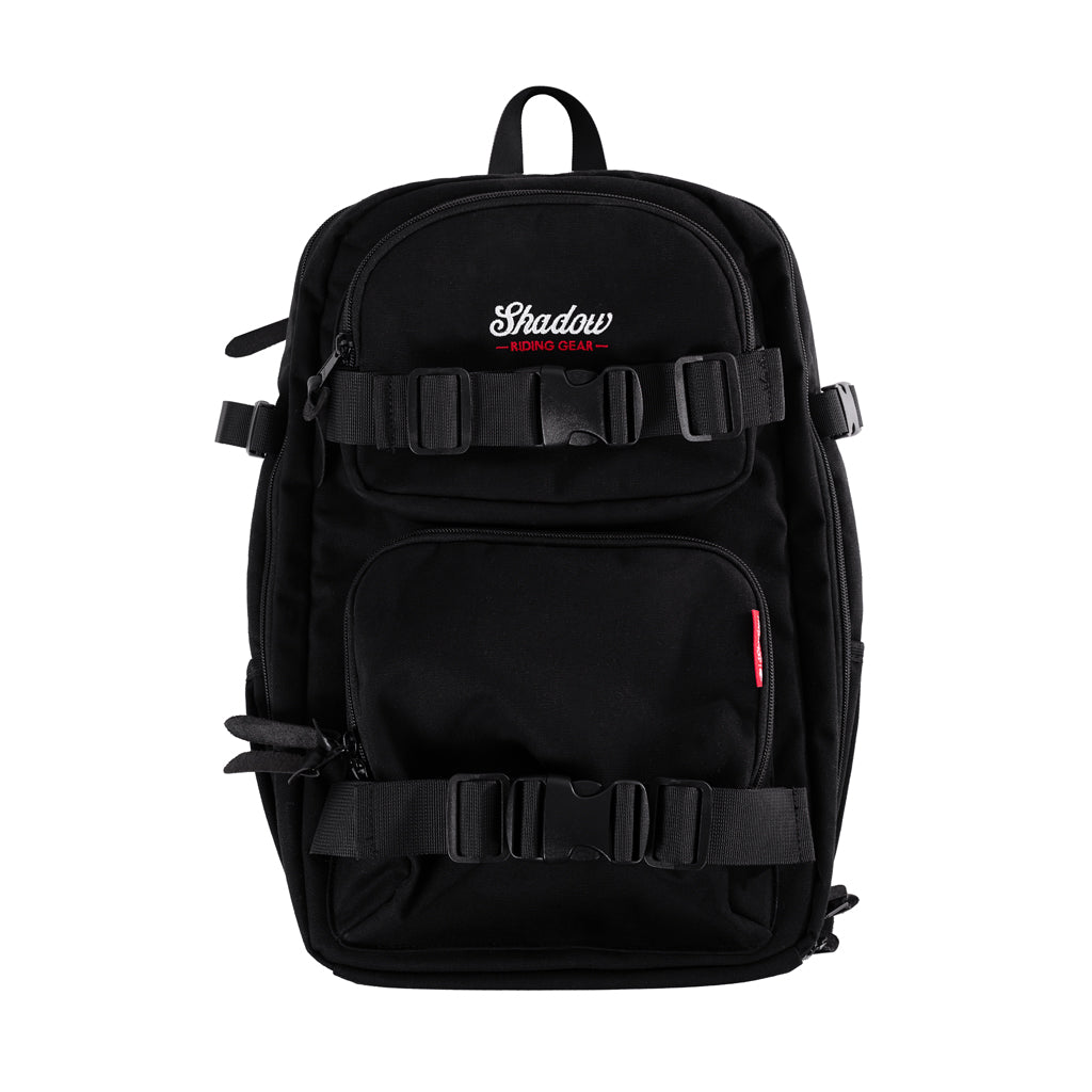 A black camera backpack with multiple compartments and straps, featuring the Shadow BMX brand logo.