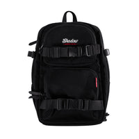 A black camera backpack with multiple compartments and straps, featuring the Shadow BMX brand logo.