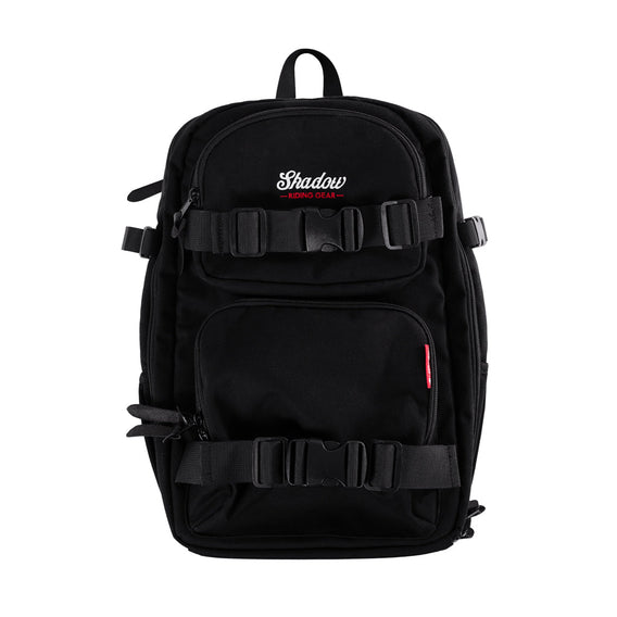A black camera backpack with multiple compartments and straps, featuring the Shadow BMX brand logo.